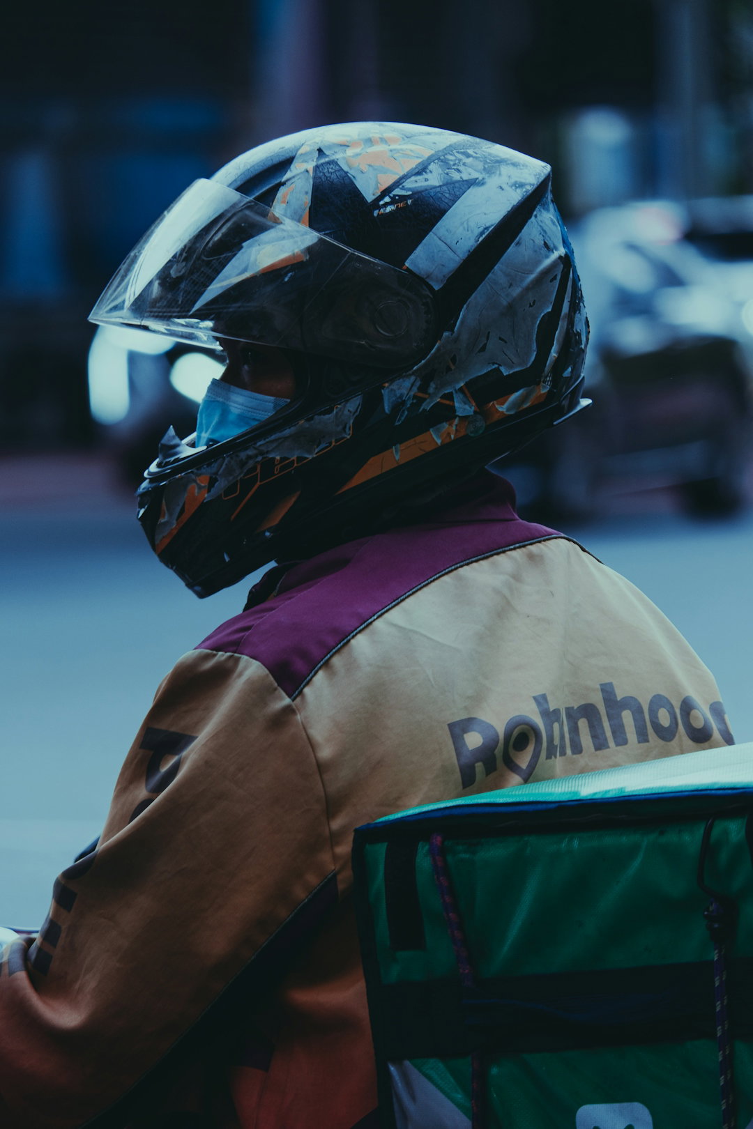 a-person-wearing-a-helmet-sitting-on-a-motorcycle.jpg a person wearing a helmet sitting on a motorcycle